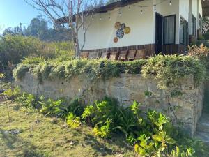 a stone wall in front of a house at Pan House Bắc Hà in Bắc Hà