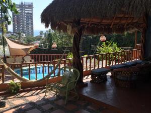 a resort with a hammock and a swimming pool at Casa de Arena in Manzanillo