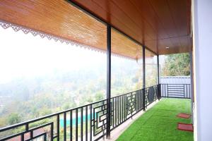 a balcony with a view of a mountain at Okhli Homestay in Kalimpong