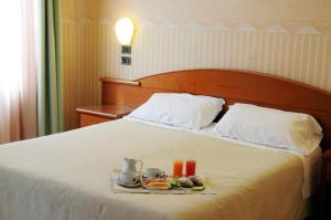 Postel nebo postele na pokoji v ubytování Hotel Button