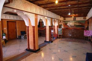a room with a lobby with pillars and a room with a table at La Kasbah De Dades in Boumalne