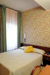 Postel nebo postele na pokoji v ubytování Hotel Button