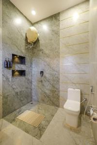 a bathroom with a toilet and a shower at SaffronStays Mont Tierra in Dehradun