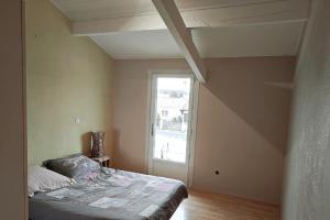 an empty room with a bed and a window at Villa avec piscine L'Abris Côtier in Mimizan +19 photos