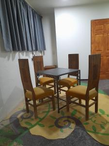 a dining room with a table and chairs on a rug at Dormitorio de La Estancia del Abuelo in San José Iturbide +18 photos