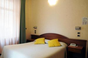 Postel nebo postele na pokoji v ubytování Hotel Button