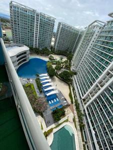 an aerial view of a resort with a pool and buildings at Azure Staycation PH 1503 in Manila