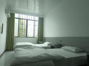Postel nebo postele na pokoji v ubytování Heleju Homestay