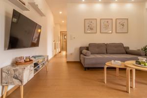 a living room with a couch and a tv at Diktamo apartment, Palaiochora in Palaiochóra
