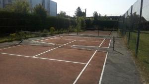 a tennis court with two tennis courts at Camping les Marguerites in Gamaches +16 photos
