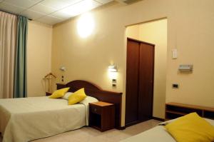 Postel nebo postele na pokoji v ubytování Hotel Button