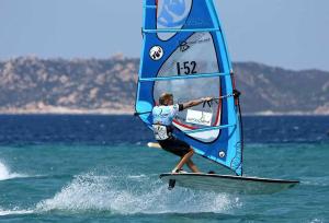a man riding a windsurfing board with a sail at Casa Marina Maria in Murta Maria