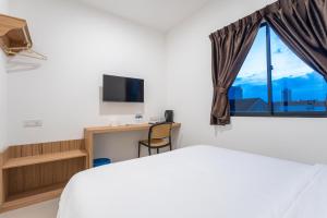 a hotel room with a bed and a window at TKT Guesthouse in Johor Bahru