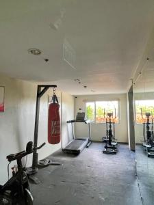 an empty room with a gym with two tread machines at Peaceful and Convenient Condo - Avida Tower in Cagayan de Oro