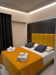 a bedroom with a large bed with towels on it at Luxury Home Station in Tropea +35 photos