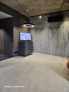a large room with a flat screen tv in it at Happy Inn VIP Lounge, self check-in, parking in Vilnius +22 photos