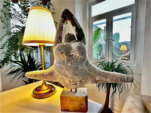 a statue of a bird sitting on a table next to a lamp at Casal Santa Virginia in Sintra