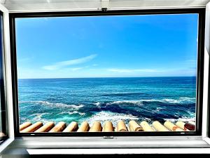 a view of the ocean from a window of a ship at Casal Santa Virginia in Sintra