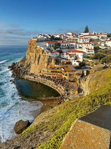 a village on a cliff next to the ocean at Casal Santa Virginia in Sintra