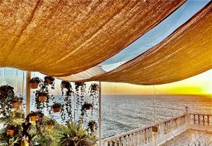 a view of the ocean from under a large umbrella at Casal Santa Virginia in Sintra