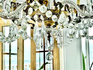 a chandelier in a room with a window at Casal Santa Virginia in Sintra