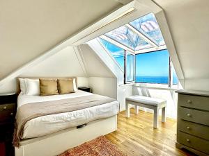 a bedroom with a bed and a large window at Casal Santa Virginia in Sintra