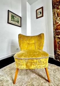 a yellow chair sitting in the corner of a room at Casal Santa Virginia in Sintra