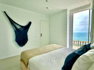 a bedroom with a bed with a view of the ocean at Casal Santa Virginia in Sintra
