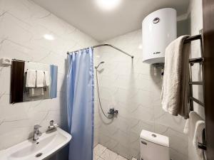 a bathroom with a blue shower curtain and a sink at Registon in Bukhara +29 photos