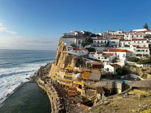 a village on a cliff next to the ocean at Casal Santa Virginia in Sintra