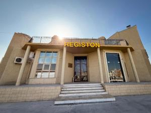 a building with a sign that reads restoration at Registon in Bukhara