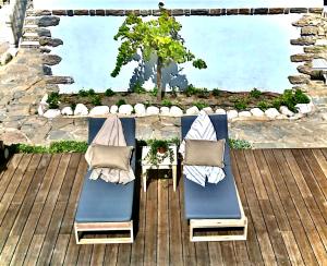 two chairs and a table on a wooden deck at Casal Santa Virginia in Sintra