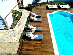 an overhead view of a pool with lounge chairs next to a swimming pool at Casal Santa Virginia in Sintra