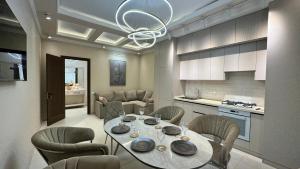a kitchen and dining room with a table and chairs at TV Tower View Apartment in Yunusobod