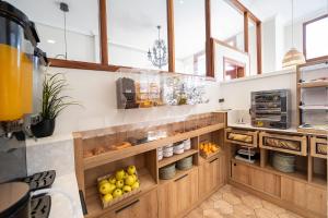 a kitchen with wooden cabinets and lots of food at Hotel Puerto de Candás in Candás