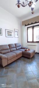 a living room with a brown couch and a window at La Terrazza sul Mare in Torre Grande
