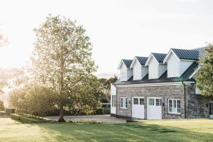 a brick house with a gambrel roof at Linnaeus Farm, Berry - by Linnaeus Collection in Berry