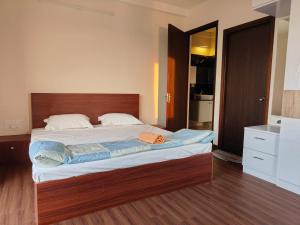 a bedroom with a large bed with a wooden headboard at Astonishing 3BHK at 6-Floor for Family only in Bengaluru +85 photos