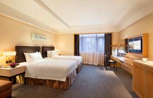 Postel nebo postele na pokoji v ubytování Yiho Hotel Xiamen Huli