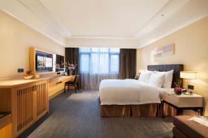 Postel nebo postele na pokoji v ubytování Yiho Hotel Xiamen Huli