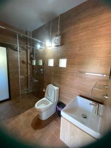 a bathroom with a toilet and a sink and a shower at Chiang Dao Story Camp in Ban Tham