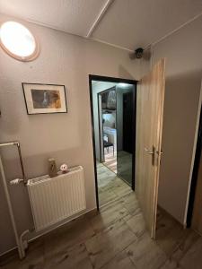 a room with a hallway with a door and a mirror at Leśny Zakątek in Łódź +13 photos