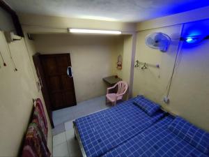 a room with a bed and a table and a chair at Jade Crown in Yangon +8 photos