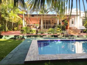 a swimming pool in front of a house at Kindo Kicha Farmhouse in Moshi