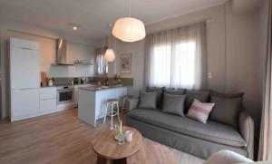 a living room with a couch and a kitchen at Blue Nights Apartments Eretria in Eretria