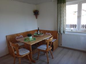 a dining room with a table and chairs and a window at Ferienbungalow in Seeboden