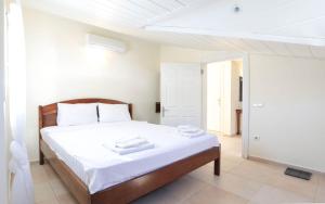 a bedroom with a large bed with white sheets at Kale Aparts in Kaş