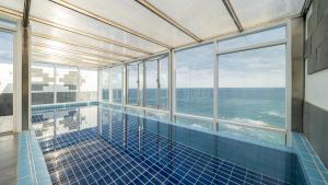 a swimming pool with a view of the ocean at Elafonisi Poolvilla & Hotel in Gyeongju