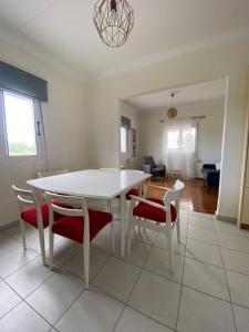 a living room with a white table and chairs at Soulis House in Zacharo +2 photos