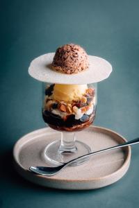 a dessert in a glass with a hat on top at Seaside Inn KOKOMO in Hakodate